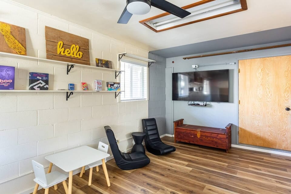 Gameroom/Lounge- Futon Couch & Two Gaming Chairs to watch movies or play Nintendo on the 65 inch Smart TV