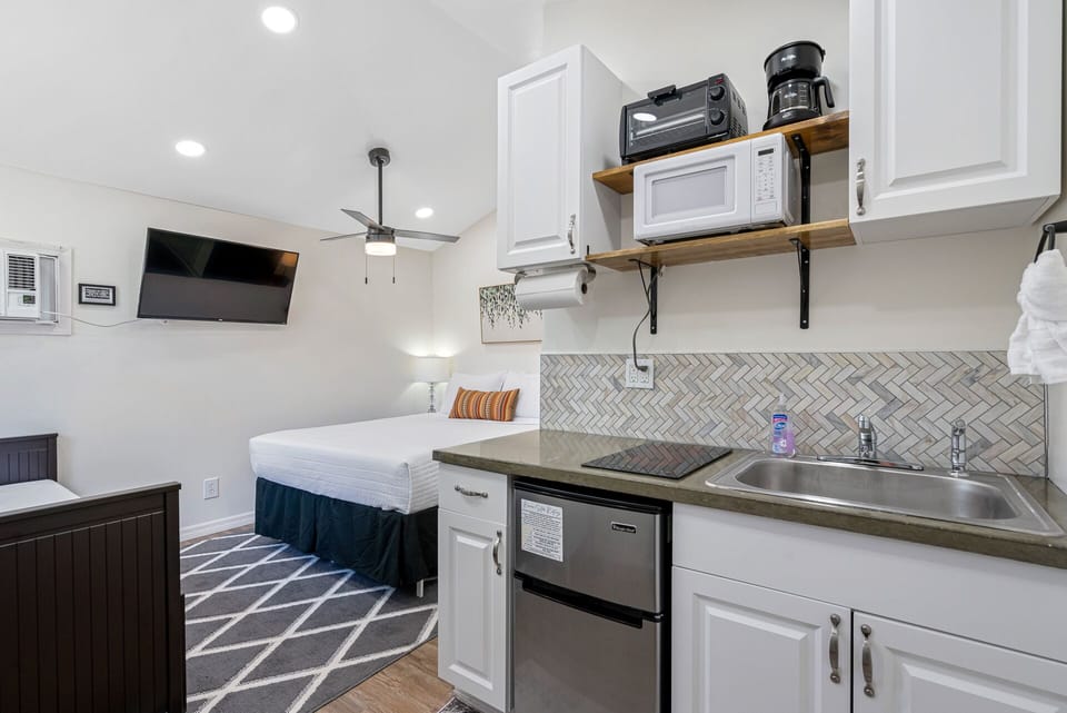 The space features a daybed, queen bed, bathroom, and kitchen. Everything you need!