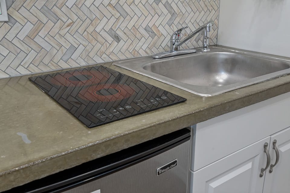 Kitchenette amenities: two-burner stove and large sink.