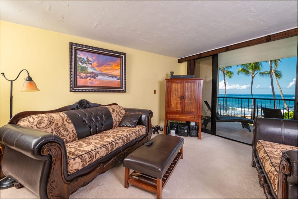 Relax in the spacious living room with enjoying the fresh ocean breeze. Bright and airy living room featuring modern décor, upgraded furnishings, and unobstructed ocean scenery through wide glass doors.