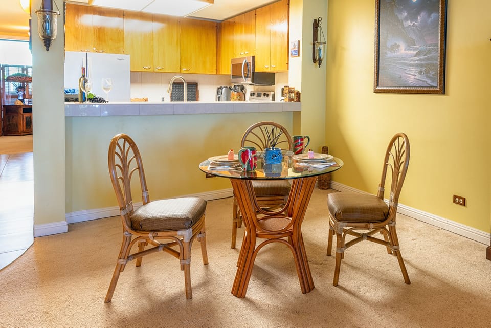 Dining Room Table is being replaced. Comfortable indoor dining space surrounded by tasteful art and soft natural light — ideal for meals or quiet evenings in.
