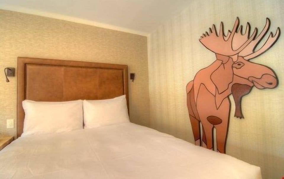There is a luxurious king-sized bed in this bright and open room.
