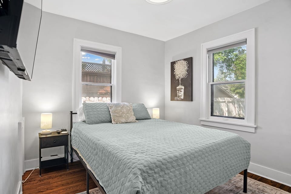 First floor bedroom with closet, queen size bed, and 43" television.