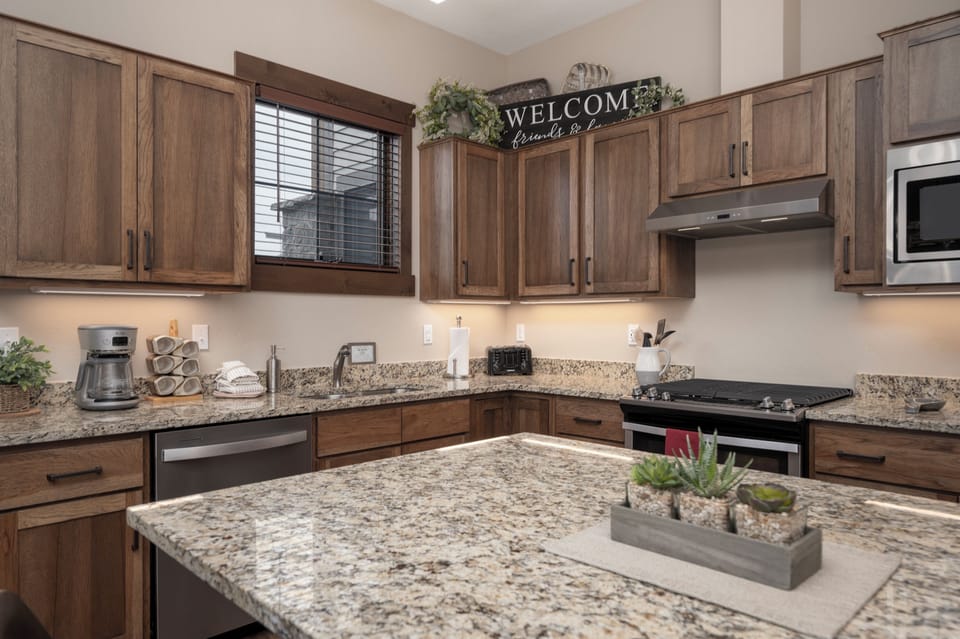 Your spacious kitchen welcomes you with granite counters, stainless appliances, and warm wood cabinets—perfect for preparing meals and creating memories.