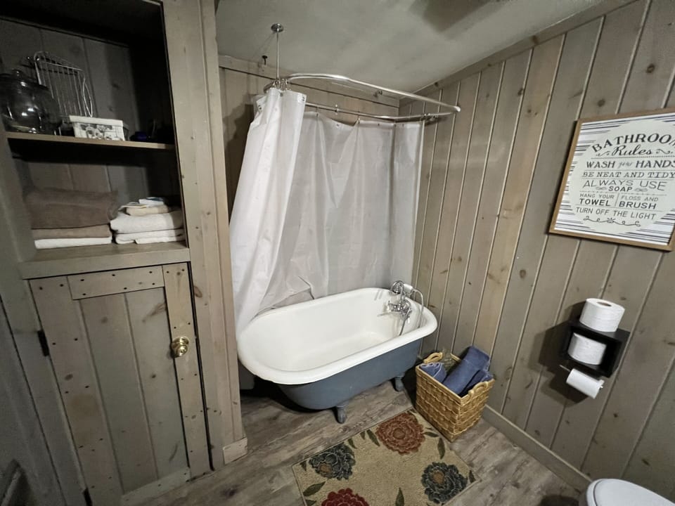 Bathroom featuring clawfoot tub with shower