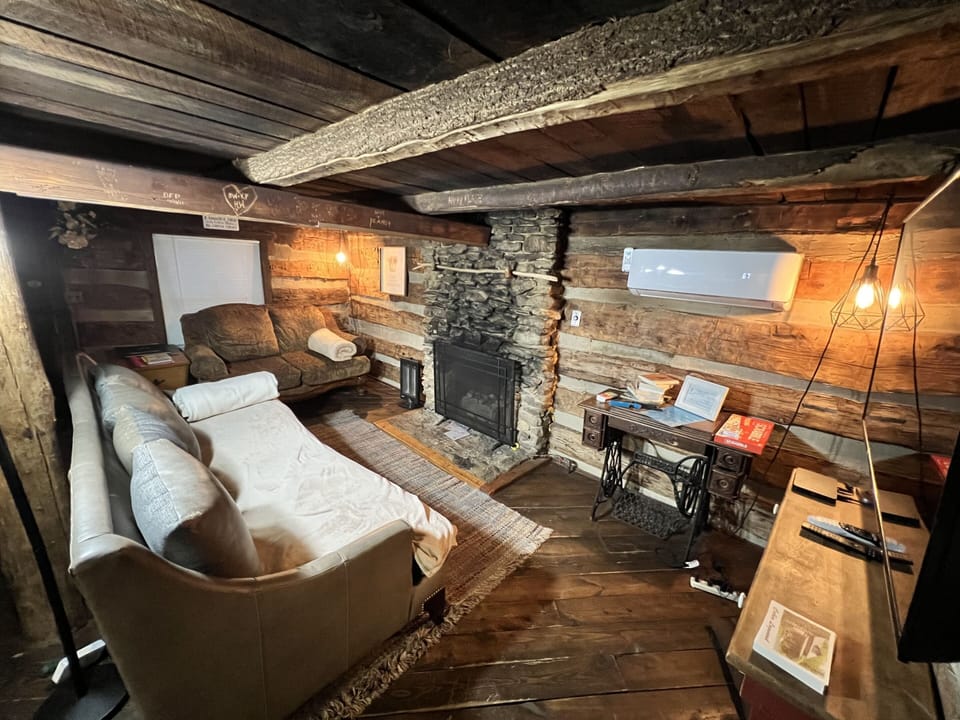 Living room features comfy couches and gas fireplace