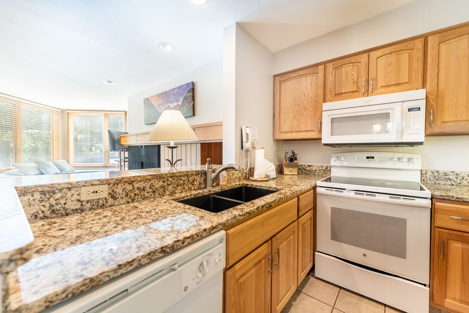 Your fully equipped kitchen features granite counters, oak cabinets, and stainless appliances—perfect for preparing meals during your stay.