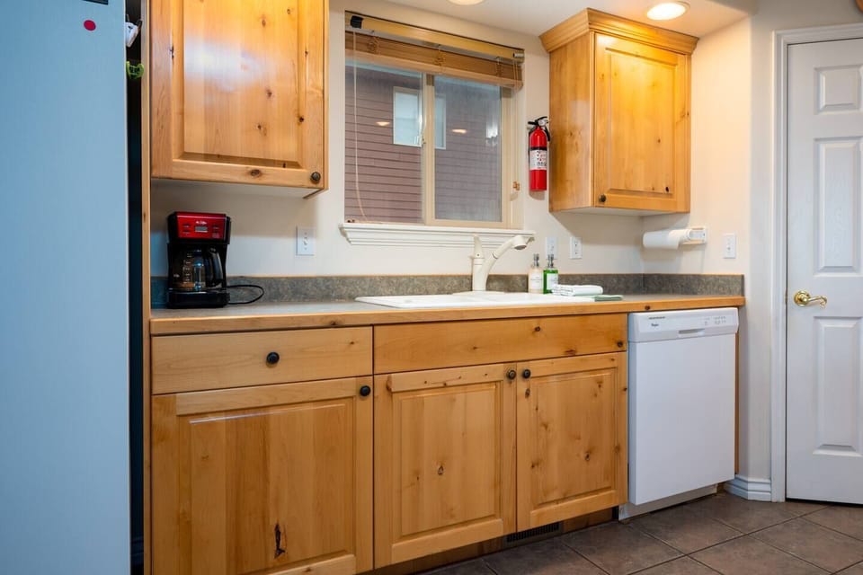 The kitchen is equipped with a dishwasher, coffee pot and plenty of natural light!