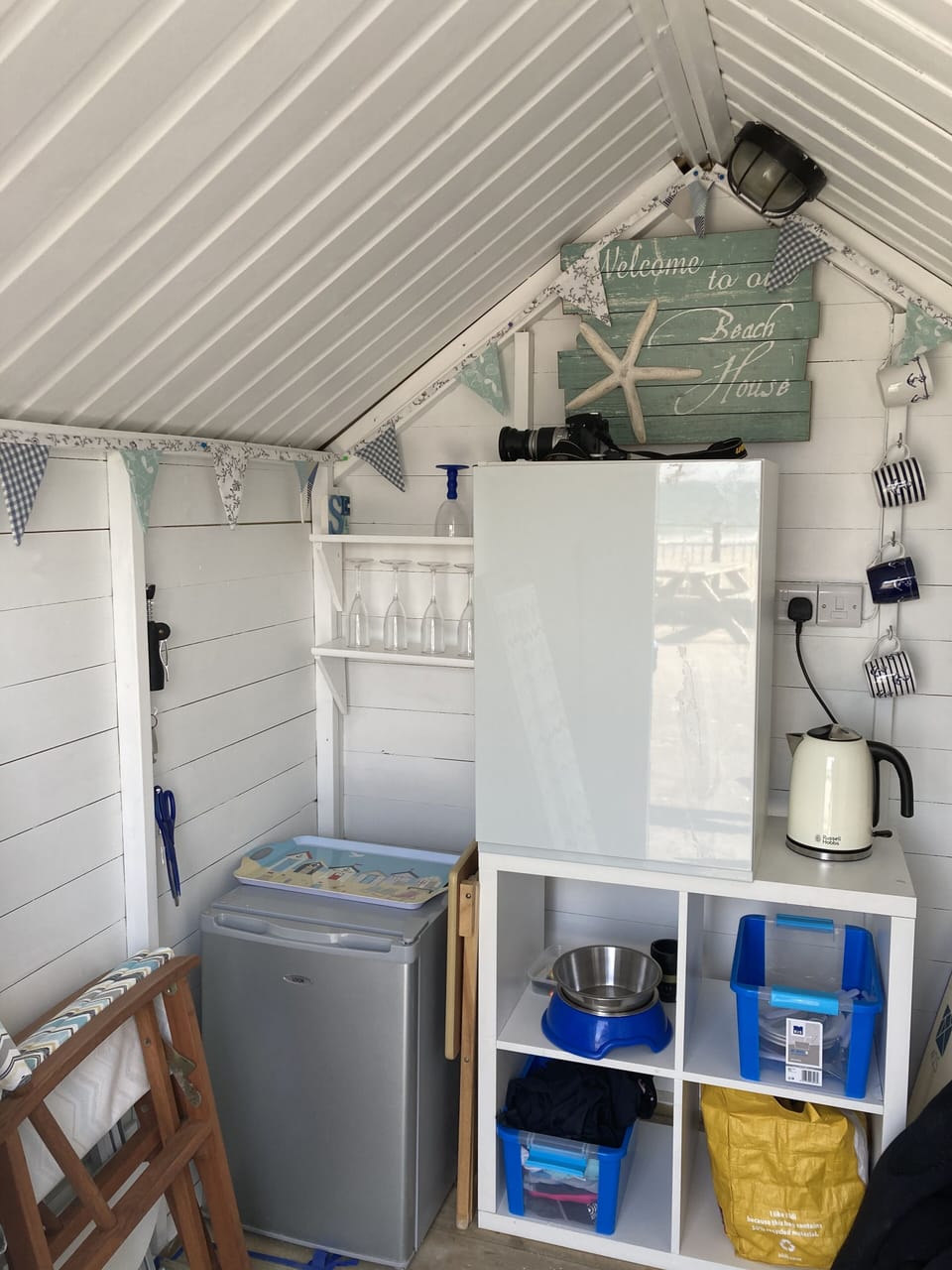 Inside the beach hut - electricity, light, fridge, deck chairs, directors chairs