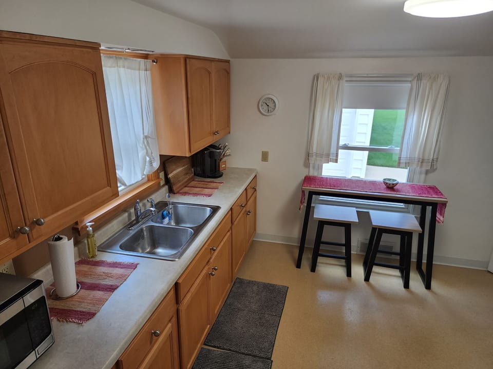 Kitchen w/ microwave, Keurig Coffee, Paper towel and plates, soaps, and sponges