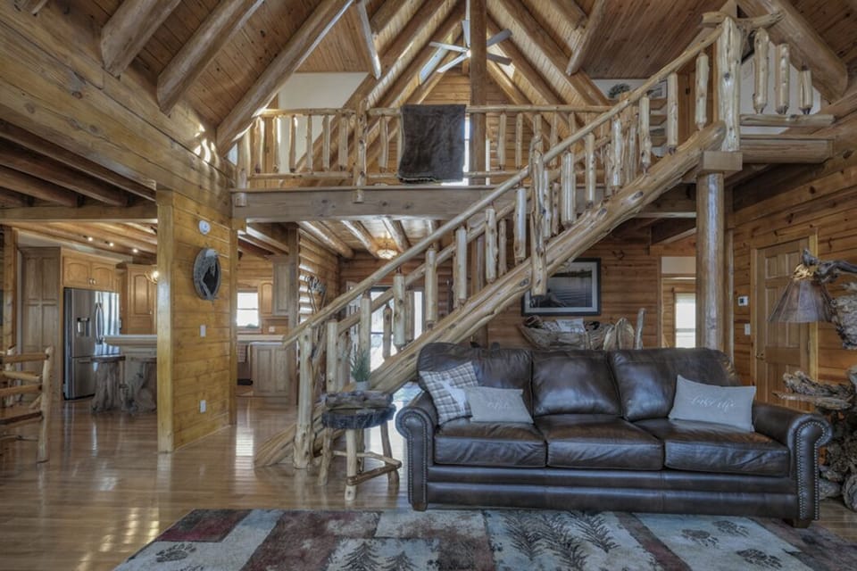 Great Hearth Room staircase and mantle feature real logs harvested from property