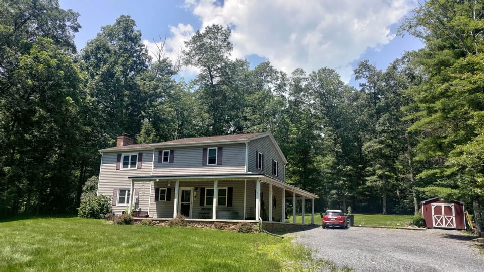 Front view w/ Porch, Parking, & Bike Shed
