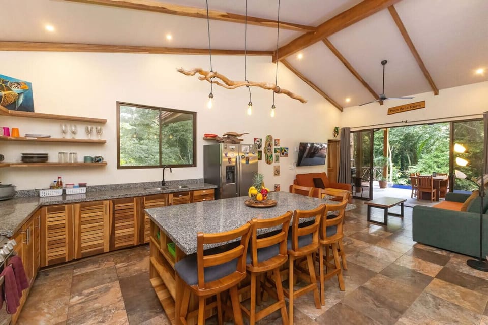 Kitchen area looks out at living room area and pool