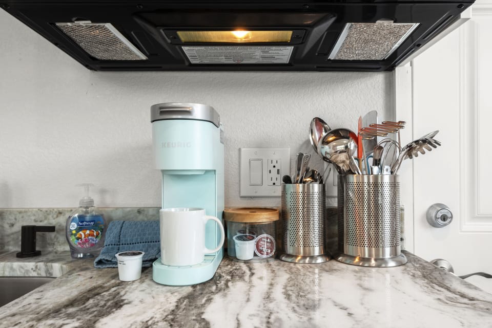 Keurig coffee maker and other kitchen utensils.