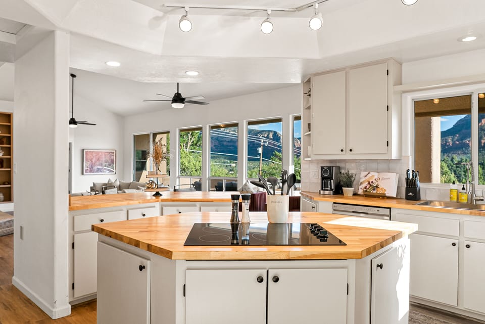 Ample counter space and a central island make it ideal for meal prep, cooking, or entertaining, all while enjoying a picturesque view to inspire your culinary creations.