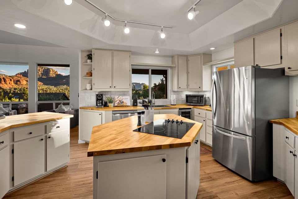 Ample counter space and a central island make it ideal for meal prep, cooking, or entertaining, all while enjoying a picturesque view to inspire your culinary creations.