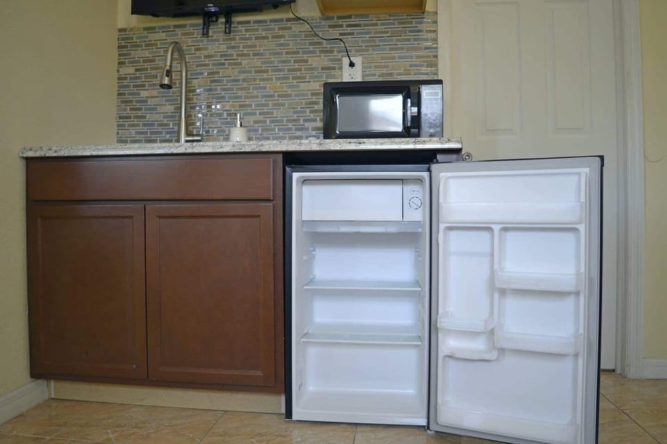 Mini refrigerator with freezer, microwave oven, kitchen cabinet, sink