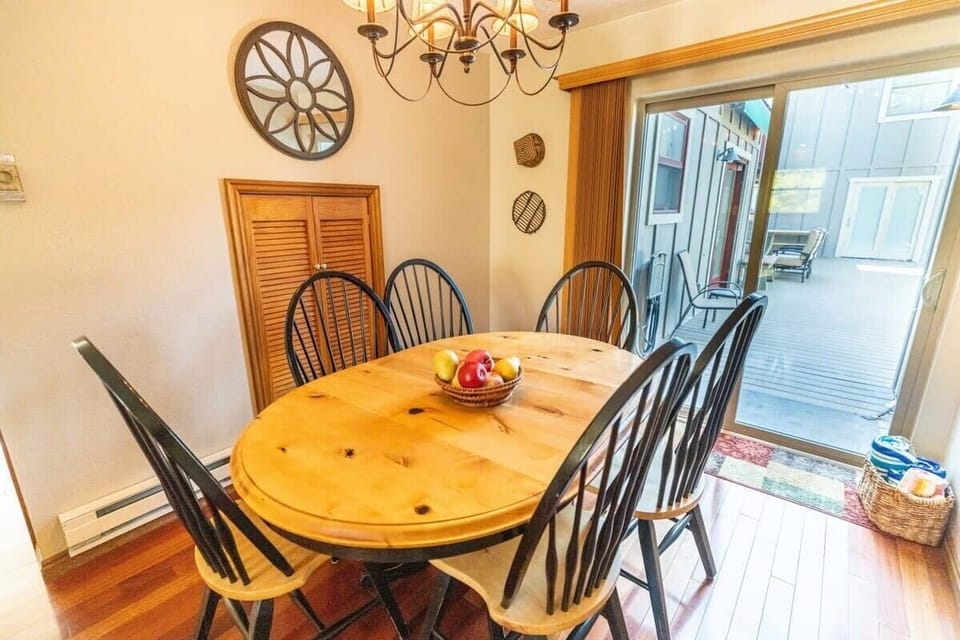 The dining area features a dining table with seating for six and access to the shared deck space which features patio seating, a BBQ grill and a spacious hot tub that can accommodate as many as 12.
