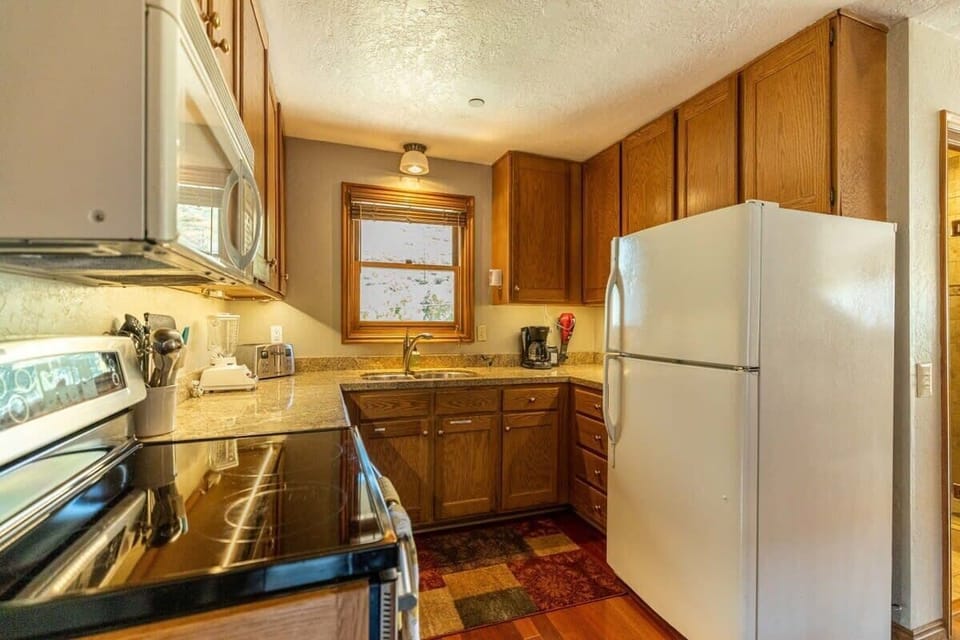 The kitchen comes complete with everything you may to prepare your meals in a cozy shared space with the dining room.