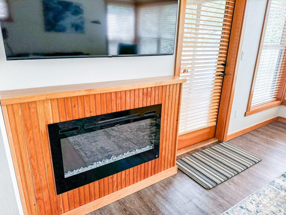 Relax by the cozy electric fireplace and enjoy a movie night on the mounted flat-screen TV in this inviting living space