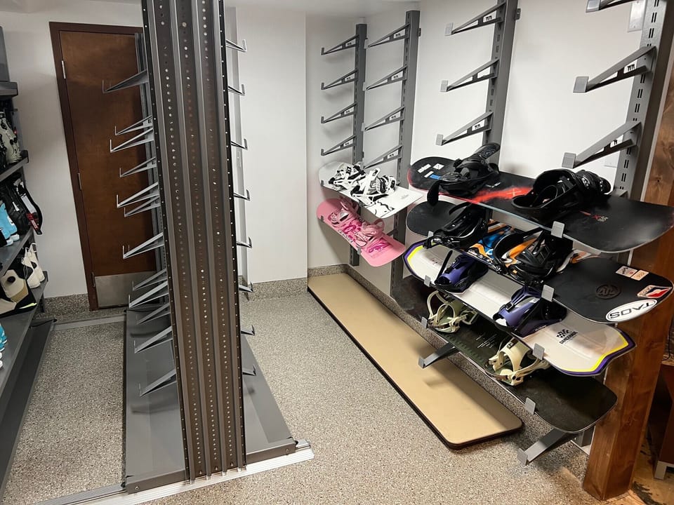 Dedicated ski storage featuring racks for skis and snowboards for easy gear drop-off after a day on the mountain.