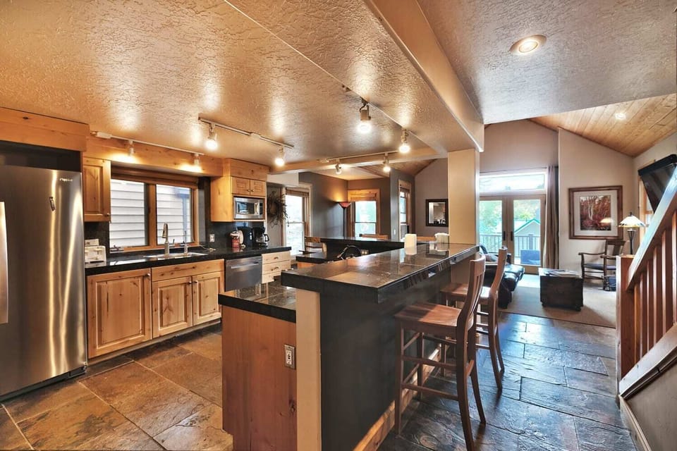 - Spacious kitchen with granite counters and bar seating  
- Fully equipped with stainless steel appliances  
- Open flow design for cooking, dining and gathering