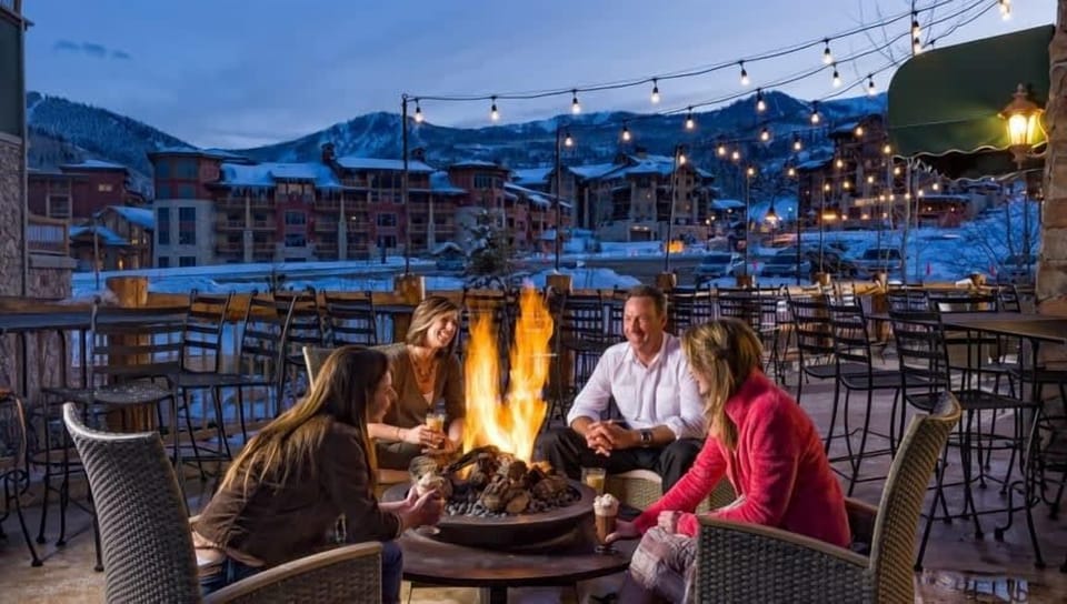 - Outdoor firepit lounge with string lights ambiance  
- Gather with friends for evening conversations  
- Scenic mountain backdrop creates a memorable setting
