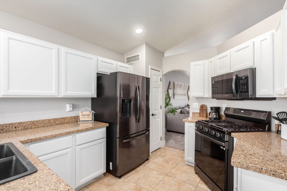 New black stainless steel appliances and a well stocked kitchen