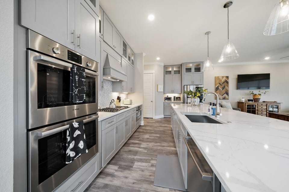 Double ovens, gas stove, full fridge, microwave, dishwasher.  