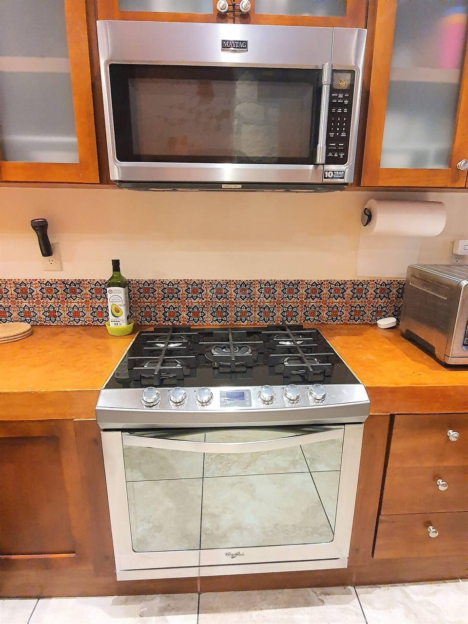 Microwave, gas stove and oven.