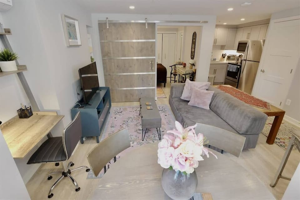 Dining table doubles as a laptop friendly workspace, as well as the desk area