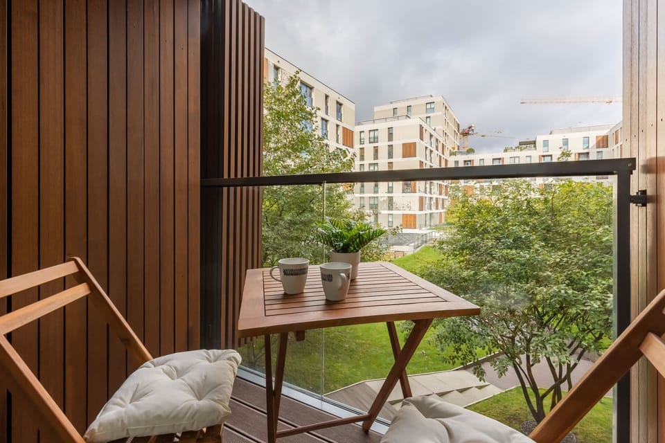 Furnished balcony with green surroundings. 