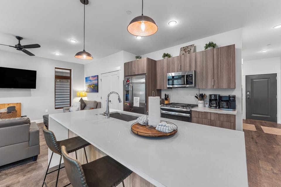 Full-sized luxury kitchen with breakfast bar seating.