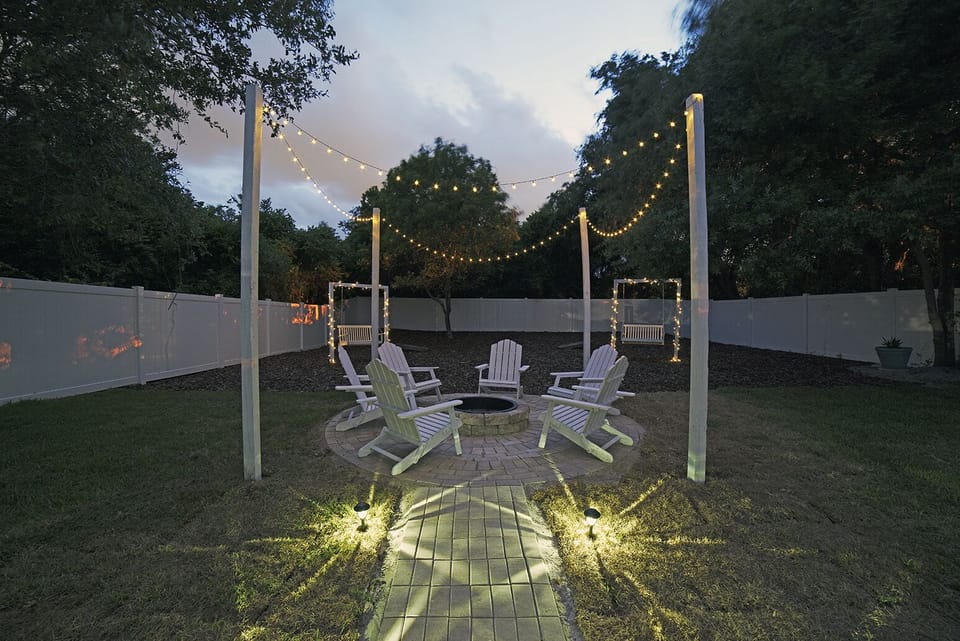 Beautiful custom-made paver walkway with fire pit.  Handmade Adirondack chairs. 