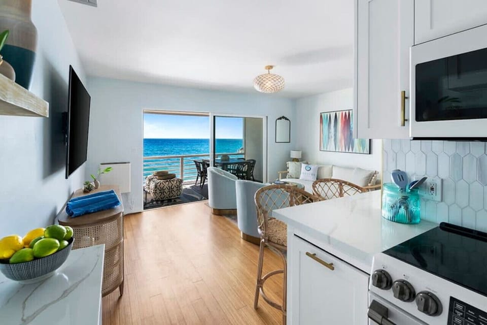 Step into a luxurious living and kitchen area haven, complete with a balcony offering ocean breezes and breathtaking views—perfect for the ultimate vacation escape.