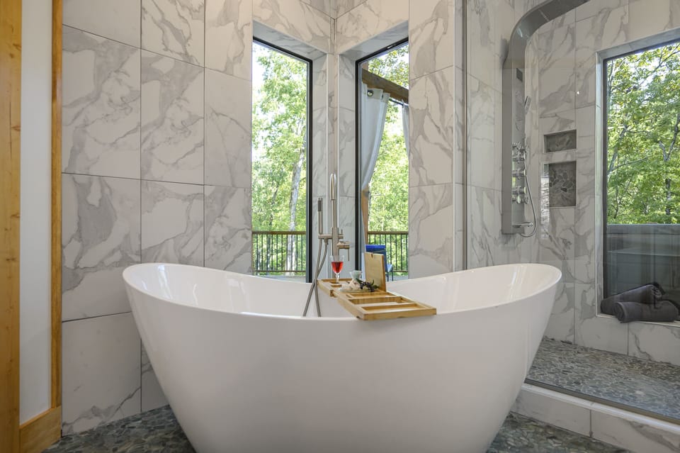 Soaking tub, windows have privacy curtains, not shown for purpose of lighting