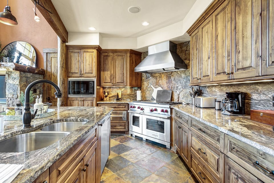 Gourmet Kitchen Excellence: A culinary delight awaits in this kitchen equipped with high-end appliances and finishing, fully stocked to cater to every gastronomic desire. 