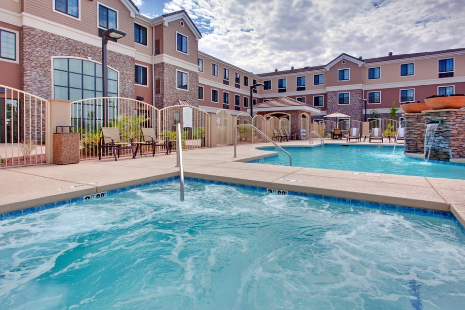 Heated spa whirlpool adjacent to outdoor swimming pool.