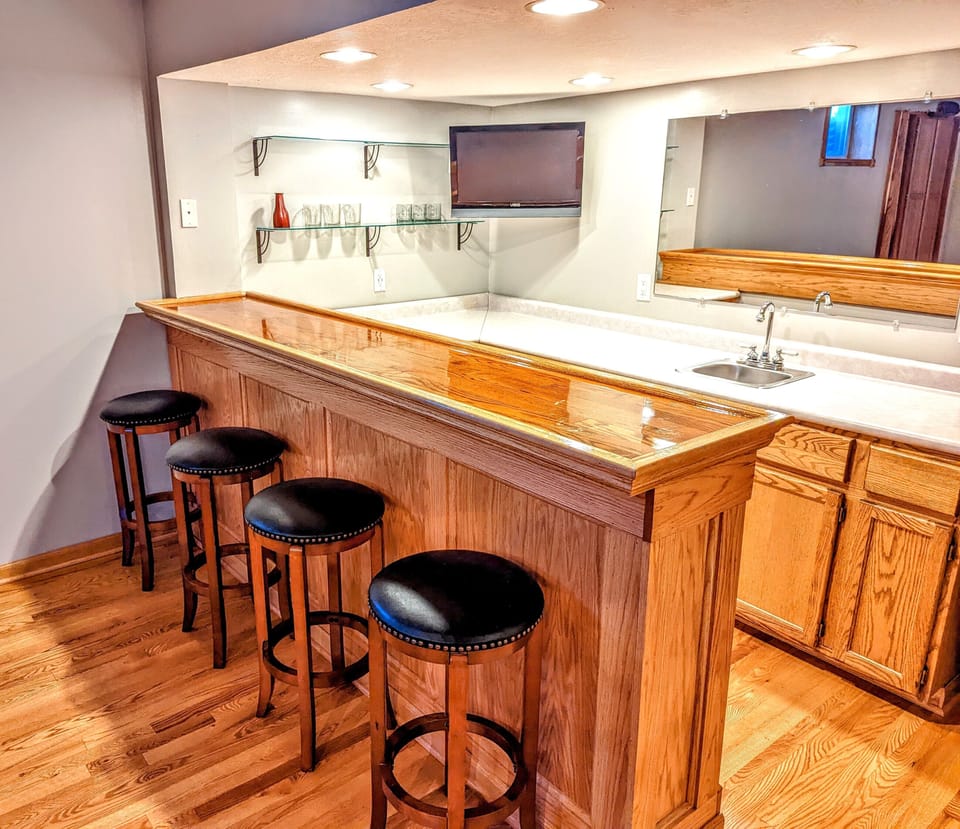 Lower level wet bar area with mini fridge and smart TV