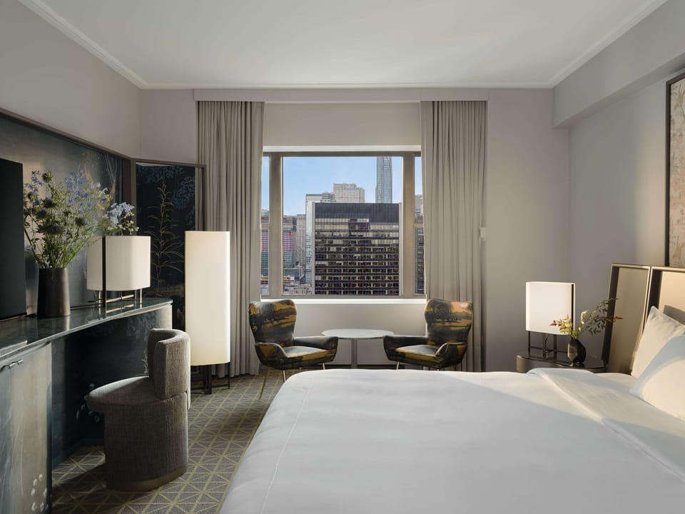 Wake up to skyline views from a plush king bed.
