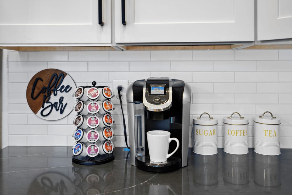 Coffee Bar with top cabinets full of sweeteners and creamers to add as you like