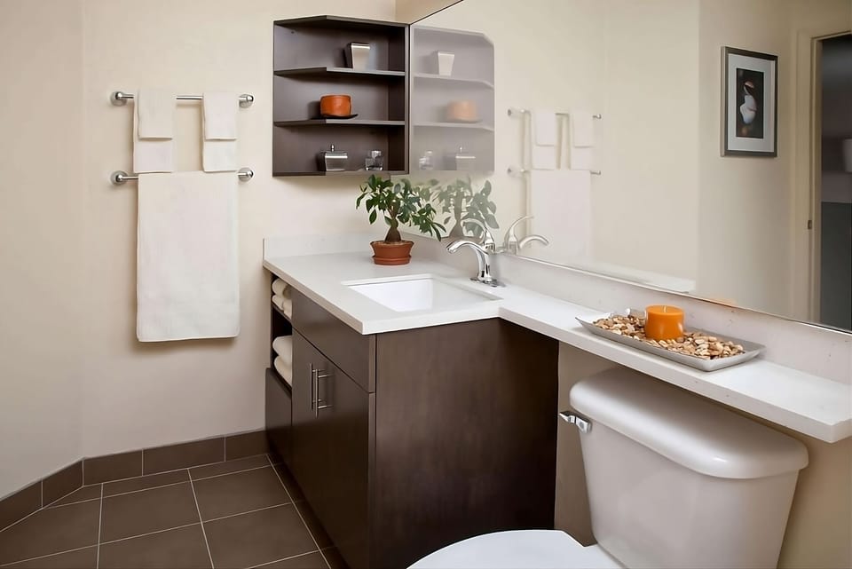 Refresh at a sleek vanity with fluffy towels and storage.