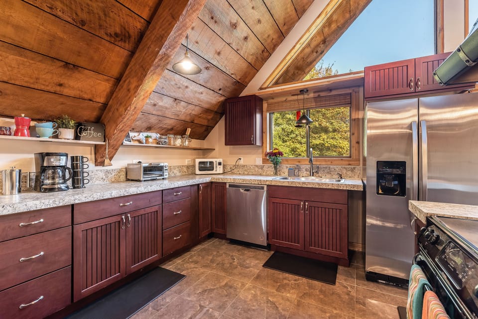 Kitchen with fully stocked coffee bar, microwave,  and toaster oven.