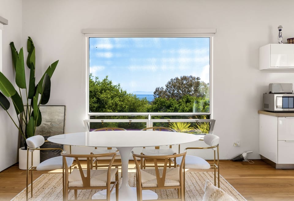 Quartz dining table overlooking ocean. King bed casita.