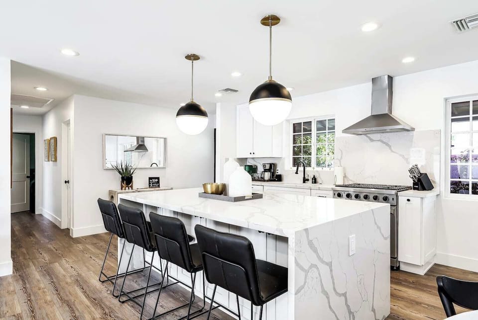 Waterfall kitchen island for a sleek modern design, fully stocked.