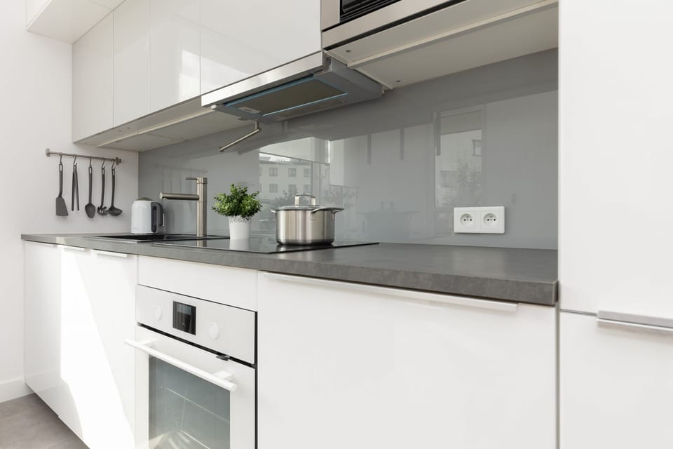 Kitchenette with oven and refrigerator. 