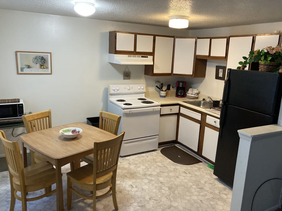 Full kitchen, with dining area.