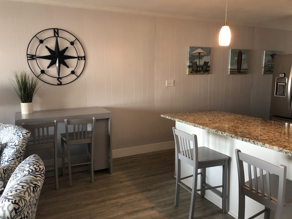 Adjust the dining table to seat 4 or relax at the bar