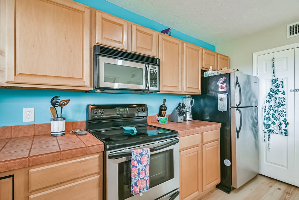 full-sized oven with tons  of cooking supplies 