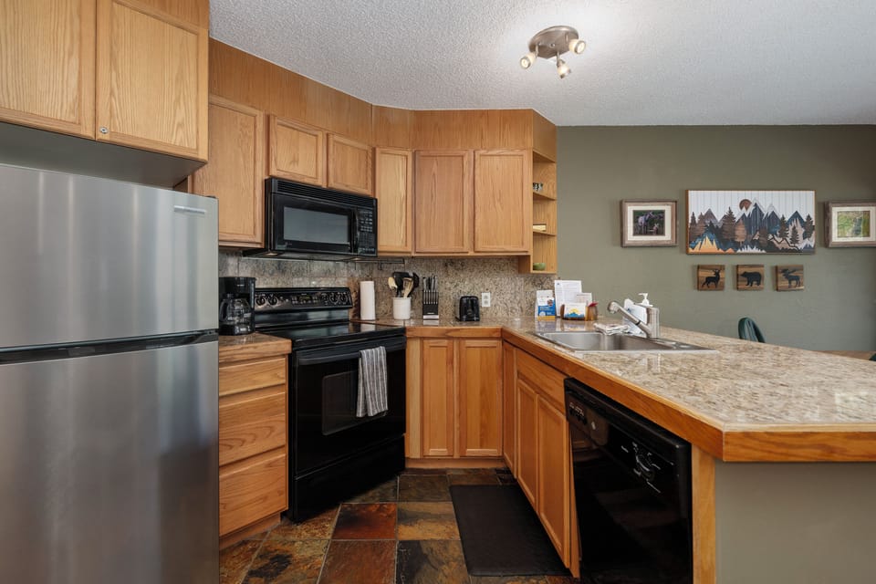 Modern kitchen stocked with utensils, appliances, and cookware to make meal prep easy.